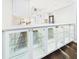 Kitchen bar featuring custom glass cabinets with stone countertops and hardwood floors at 4534 La Jolla Dr, Bradenton, FL 34210