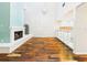Spacious open concept living area with fireplace and adjoining kitchen with glass bar cabinets and hardwood flooring at 4534 La Jolla Dr, Bradenton, FL 34210