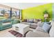 Cozy living room with bright accent wall, comfortable seating, and natural light at 4534 La Jolla Dr, Bradenton, FL 34210
