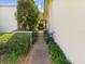 Enchanting walkway through lush greenery and decorative iron gate, leading to the home at 4534 La Jolla Dr, Bradenton, FL 34210