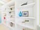 Built-in white shelves with decorative accents, providing ample display and storage space at 4534 La Jolla Dr, Bradenton, FL 34210