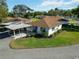 Aerial view of a well-maintained single-story home with a carport and lush green landscaping at 5020 Live Oak Cir, Bradenton, FL 34207