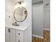 Modern bathroom with a stylish vanity, round mirror, and updated lighting at 5020 Live Oak Cir, Bradenton, FL 34207