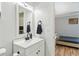 Updated bathroom featuring a white vanity, mirror, modern fixtures, and view into bedroom at 5020 Live Oak Cir, Bradenton, FL 34207