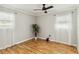 Bright bedroom featuring modern ceiling fan, light gray walls, light-colored wood floor and plant at 5020 Live Oak Cir, Bradenton, FL 34207