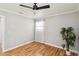 Bright bedroom featuring modern ceiling fan, light gray walls, light-colored wood floor and plant at 5020 Live Oak Cir, Bradenton, FL 34207