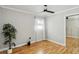 Bright bedroom featuring modern ceiling fan, light gray walls, light-colored wood floor and plant at 5020 Live Oak Cir, Bradenton, FL 34207