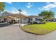 Charming single-story home featuring a covered carport, manicured lawn, and welcoming front entrance at 5020 Live Oak Cir, Bradenton, FL 34207