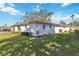 Exterior view of property featuring beautiful landscaping with mature trees and green lawns at 5020 Live Oak Cir, Bradenton, FL 34207