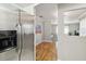 Modern kitchen with stainless steel refrigerator, light walls, and hardwood flooring at 5020 Live Oak Cir, Bradenton, FL 34207