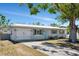 Charming single-story home with a well-maintained lawn and a metal roof, offering both curb appeal and durability at 5026 Brookmeade Dr, Sarasota, FL 34232