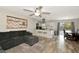 Inviting living room featuring wood-look flooring, a ceiling fan, and seamless open layout with the adjacent kitchen at 5026 Brookmeade Dr, Sarasota, FL 34232