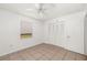 This bedroom features tile flooring, window, a ceiling fan, and closet at 5072 Vinson Way, Sarasota, FL 34232