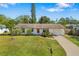 Charming single-story home with a well-maintained lawn and manicured landscaping at 5072 Vinson Way, Sarasota, FL 34232