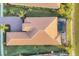 Aerial view of the home highlighting the waterfront location, private pool, and tiled roof at 525 Maraviya Blvd, Nokomis, FL 34275
