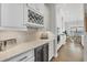 Modern bar area featuring wine storage, a beverage fridge, and sleek countertops at 525 Maraviya Blvd, Nokomis, FL 34275