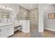 Bathroom featuring a glass enclosed shower, vanity, makeup station and wood tile flooring at 525 Maraviya Blvd, Nokomis, FL 34275