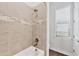 Bathroom featuring a tiled tub and shower combination, and wood look tile flooring at 525 Maraviya Blvd, Nokomis, FL 34275