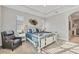 Primary bedroom featuring a decorative bed, tray ceiling with fan, and lots of sunlight at 525 Maraviya Blvd, Nokomis, FL 34275