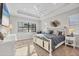 Bright bedroom featuring a decorative bed, tray ceiling with fan, and lots of sunlight at 525 Maraviya Blvd, Nokomis, FL 34275