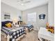 Comfortable bedroom with twin beds, ceiling fan, beach art and nautical decor at 525 Maraviya Blvd, Nokomis, FL 34275