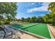 Community bocce court surrounded by lush landscaping and serene lake views at 525 Maraviya Blvd, Nokomis, FL 34275
