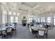 Large club room with fireplace, ample seating, and a wall of windows at 525 Maraviya Blvd, Nokomis, FL 34275