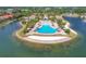 Overhead shot of an island oasis featuring a large pool, clubhouse, palm trees and waterfront views at 525 Maraviya Blvd, Nokomis, FL 34275