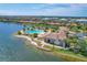Aerial view of the resort-style community pool, clubhouse, and beautiful lakefront property in a desirable neighborhood at 525 Maraviya Blvd, Nokomis, FL 34275