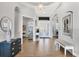 A stunning foyer featuring wood-look floors, a view to the front door and beautiful art at 525 Maraviya Blvd, Nokomis, FL 34275
