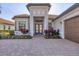 Lovely front entry showcases the home's address, lush landscaping and a gorgeous front door at 525 Maraviya Blvd, Nokomis, FL 34275