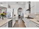 White kitchen with stainless steel appliances, granite countertops and tile backsplash at 525 Maraviya Blvd, Nokomis, FL 34275