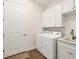 Laundry room featuring a white washer and dryer with countertop sink at 525 Maraviya Blvd, Nokomis, FL 34275
