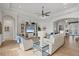 Bright living room with ceiling fan, entertainment center, and wood-look tile flooring at 525 Maraviya Blvd, Nokomis, FL 34275