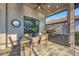 Outdoor kitchen with built-in grill and dining area on a covered patio at 525 Maraviya Blvd, Nokomis, FL 34275