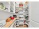 Walk-in pantry with custom shelving, butcher block countertop, and organized storage solutions at 525 Maraviya Blvd, Nokomis, FL 34275