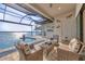 Screened patio with comfortable seating overlooking the open water at 525 Maraviya Blvd, Nokomis, FL 34275