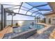 Sparkling pool and spa with water views and a screened enclosure at 525 Maraviya Blvd, Nokomis, FL 34275