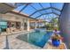 Stunning screened pool and spa with an outdoor lounge area, and view of the house at 525 Maraviya Blvd, Nokomis, FL 34275