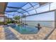 Backyard oasis with pool, spa, and screened enclosure, overlooking the water at 525 Maraviya Blvd, Nokomis, FL 34275