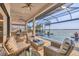 Covered patio with an outdoor kitchen, pool, hot tub, and beautiful water view at 525 Maraviya Blvd, Nokomis, FL 34275