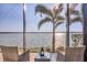 Stunning water view from the home's screened-in lanai, with seating for enjoying the outdoors at 525 Maraviya Blvd, Nokomis, FL 34275