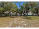 Large fenced backyard with mature trees offers shade and privacy at 5571 Riverbluff Cir # V1, Sarasota, FL 34231