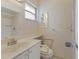 Clean bathroom featuring a shower, vanity, and white patterned wallpaper, with safety bars at 5571 Riverbluff Cir # V1, Sarasota, FL 34231