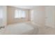 Neutral bedroom featuring a window with blinds and a door to the adjacent bathroom at 5571 Riverbluff Cir # V1, Sarasota, FL 34231