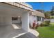 The attached carport features a paved driveway, with landscaping that leads to the front door at 5571 Riverbluff Cir # V1, Sarasota, FL 34231