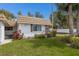 Charming single-story home features a well-manicured lawn, and a stone wall accent at 5571 Riverbluff Cir # V1, Sarasota, FL 34231