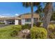 Charming single-story home features a well-manicured lawn, carport, and stone accents at 5571 Riverbluff Cir # V1, Sarasota, FL 34231