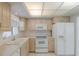 Bright kitchen with tile floors, wooden cabinetry, and modern appliances at 5571 Riverbluff Cir # V1, Sarasota, FL 34231