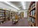 Well-stocked community library with books, comfortable seating, and ample lighting at 5571 Riverbluff Cir # V1, Sarasota, FL 34231
